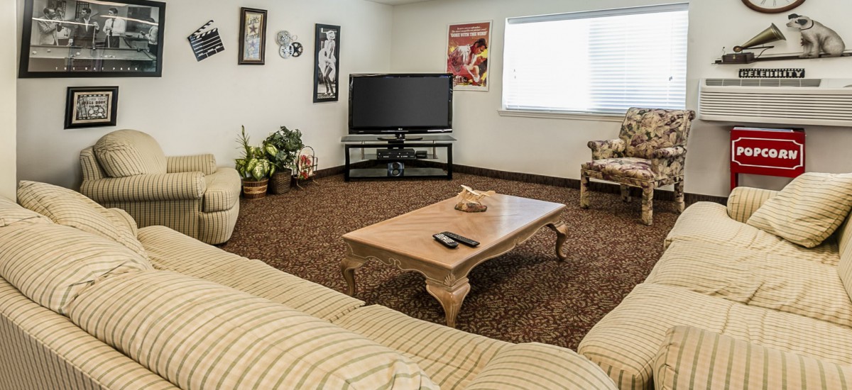 Cozy living room with a television, coffee table, and comfortable seating.