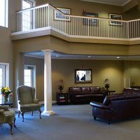 A spacious lobby with elegant furnishings and a balcony view.