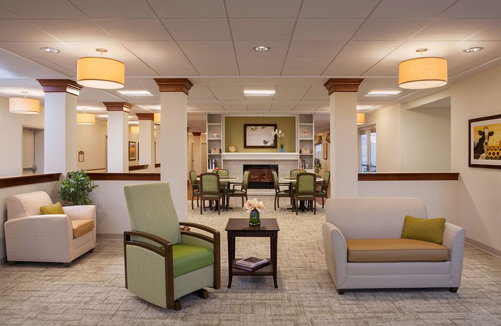 A modern and cozy living room with comfortable seating and warm lighting.