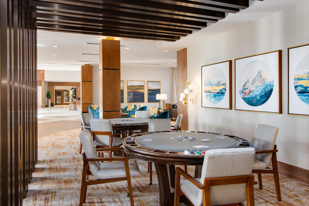 A modern hotel lounge area with seating and artwork on the walls.