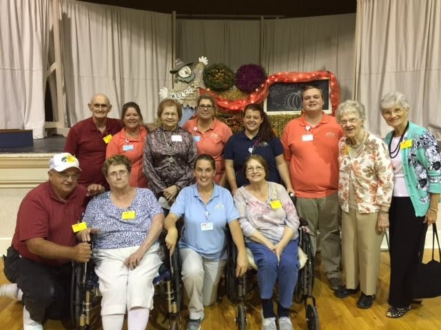 A group of people posing for a photo at an indoor gathering.