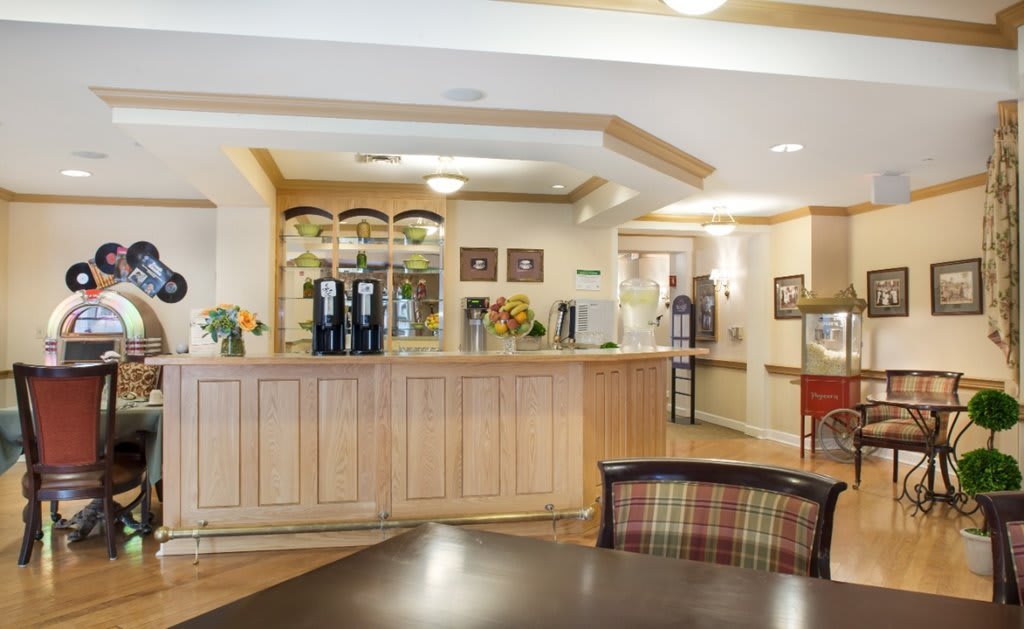 A welcoming hotel lobby with a wooden reception desk and warm lighting.