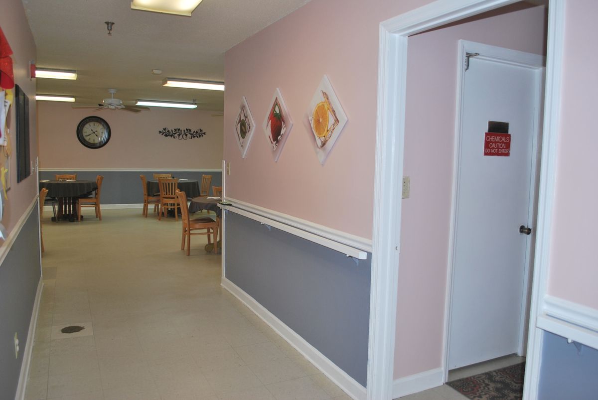 A hallway with wall art and seating area.