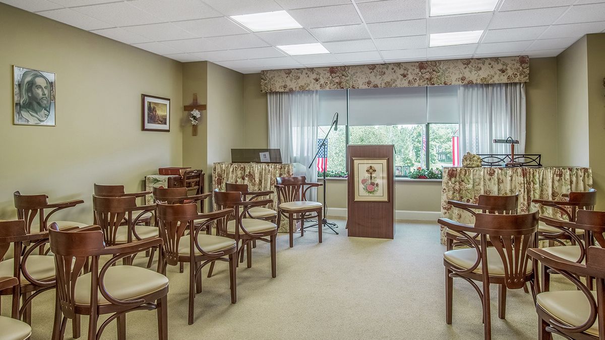 A well-lit conference room with multiple chairs and a podium, suitable for meetings or presentations.