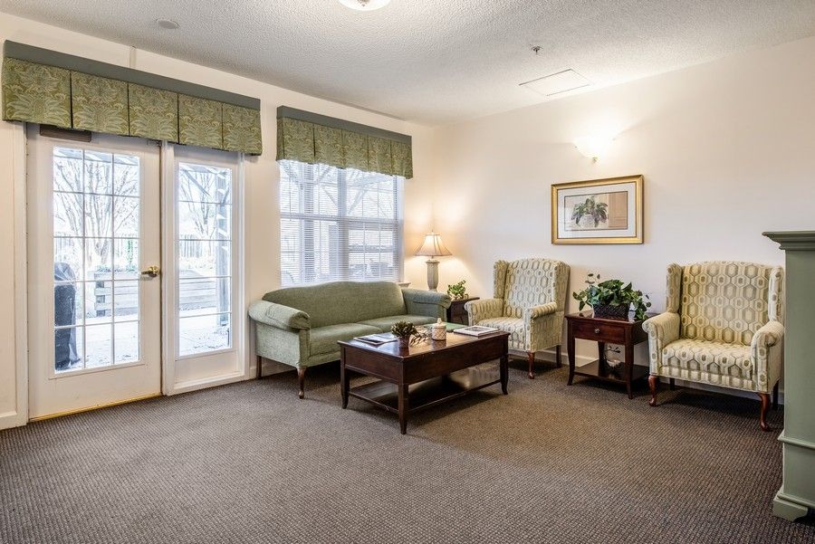 A cozy living room with sofas, armchairs, and a coffee table.