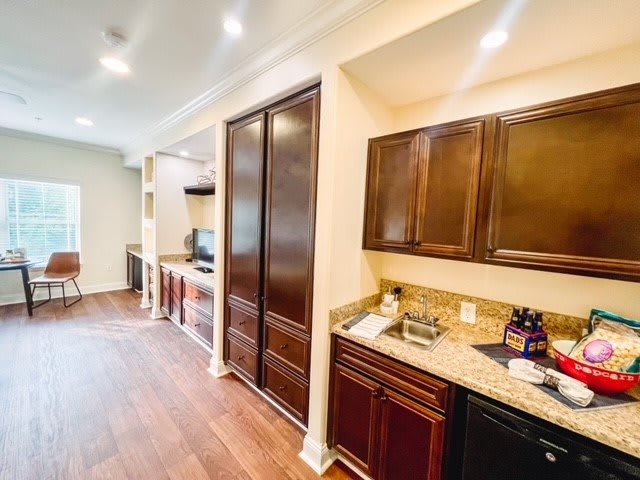 A modern kitchen with wooden cabinets and hardwood flooring.