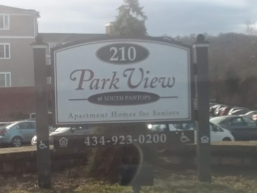 Sign for Park View Apartments located at 210, featuring contact information.