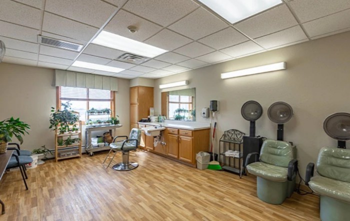 A spacious and well-lit hair salon with modern furniture and equipment.