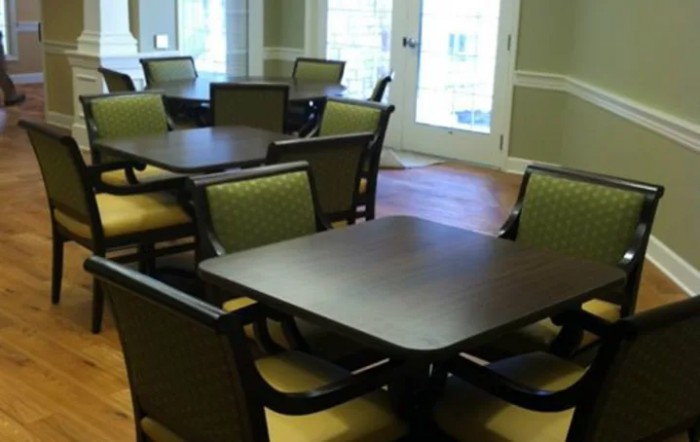An empty dining area with multiple tables and chairs arranged neatly.