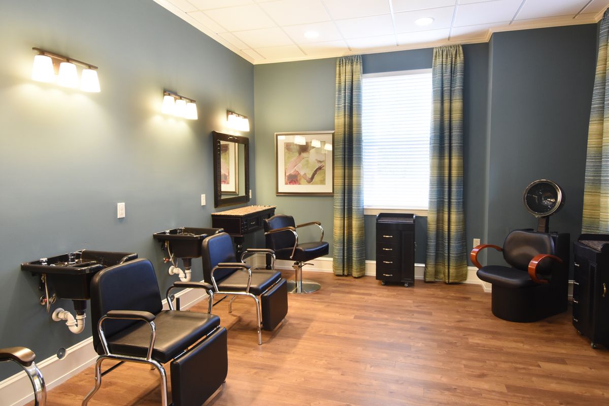 A cozy and well-lit hair salon with styling chairs and mirrors.