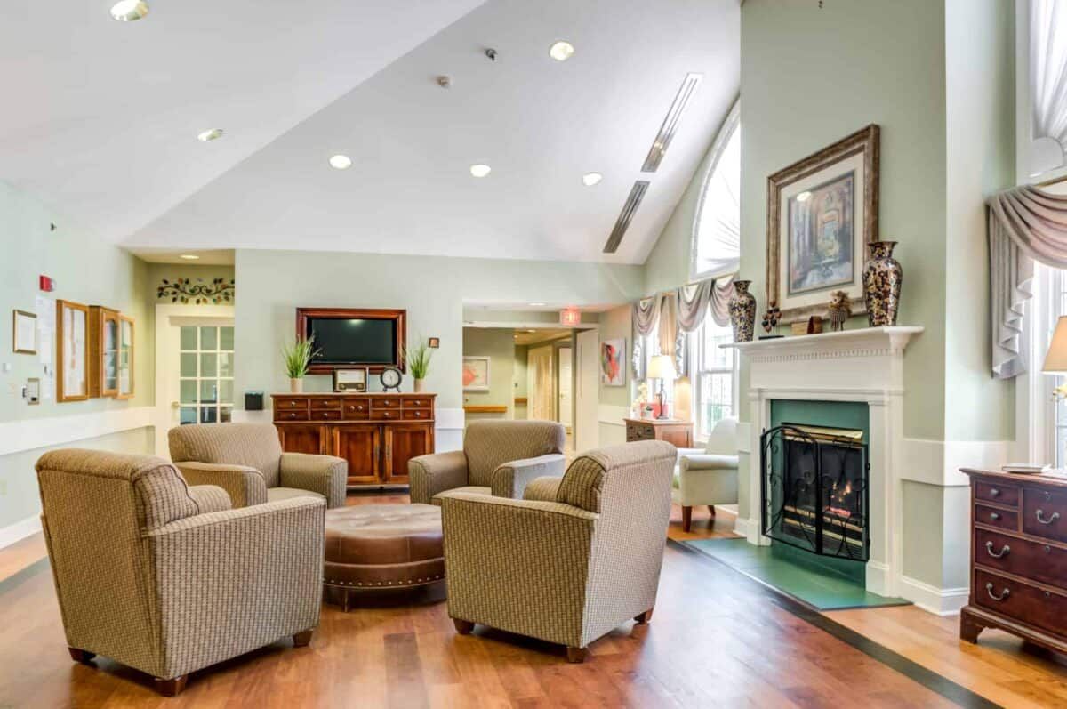 A cozy living room with a fireplace, surrounded by comfortable seating and tasteful decor.