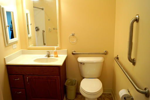 A clean and simple bathroom featuring essential fixtures like a toilet, sink, and mirror.