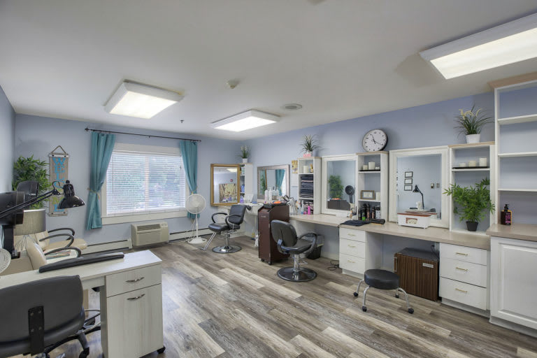 A modern salon interior with styling stations and equipment.
