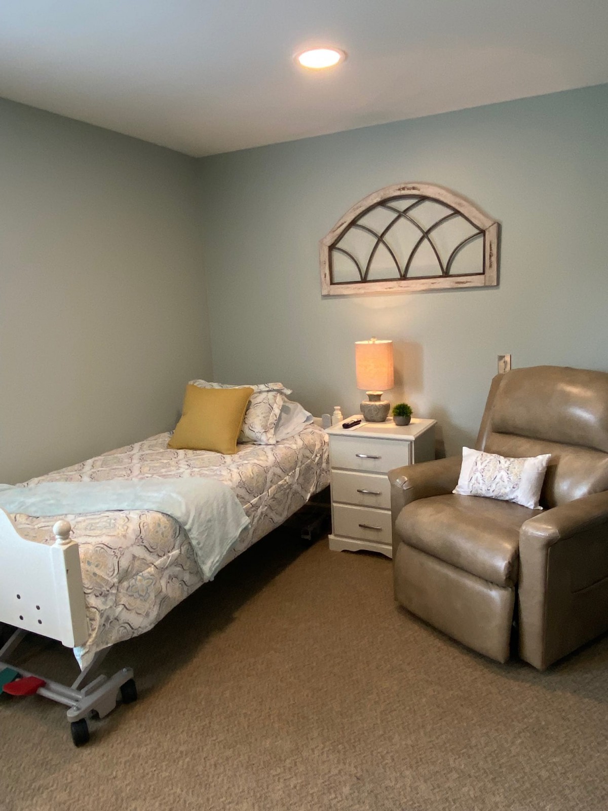 A cozy bedroom with a single bed and armchair.