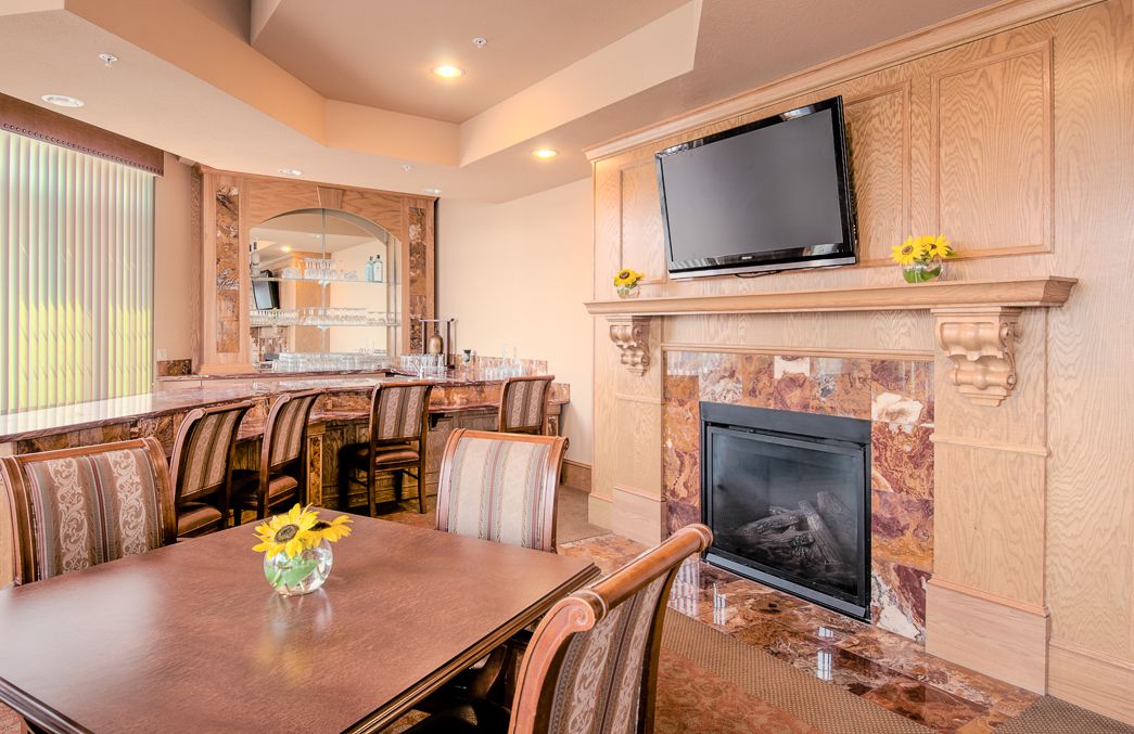Cozy living room with a fireplace, television, and elegant dining area.