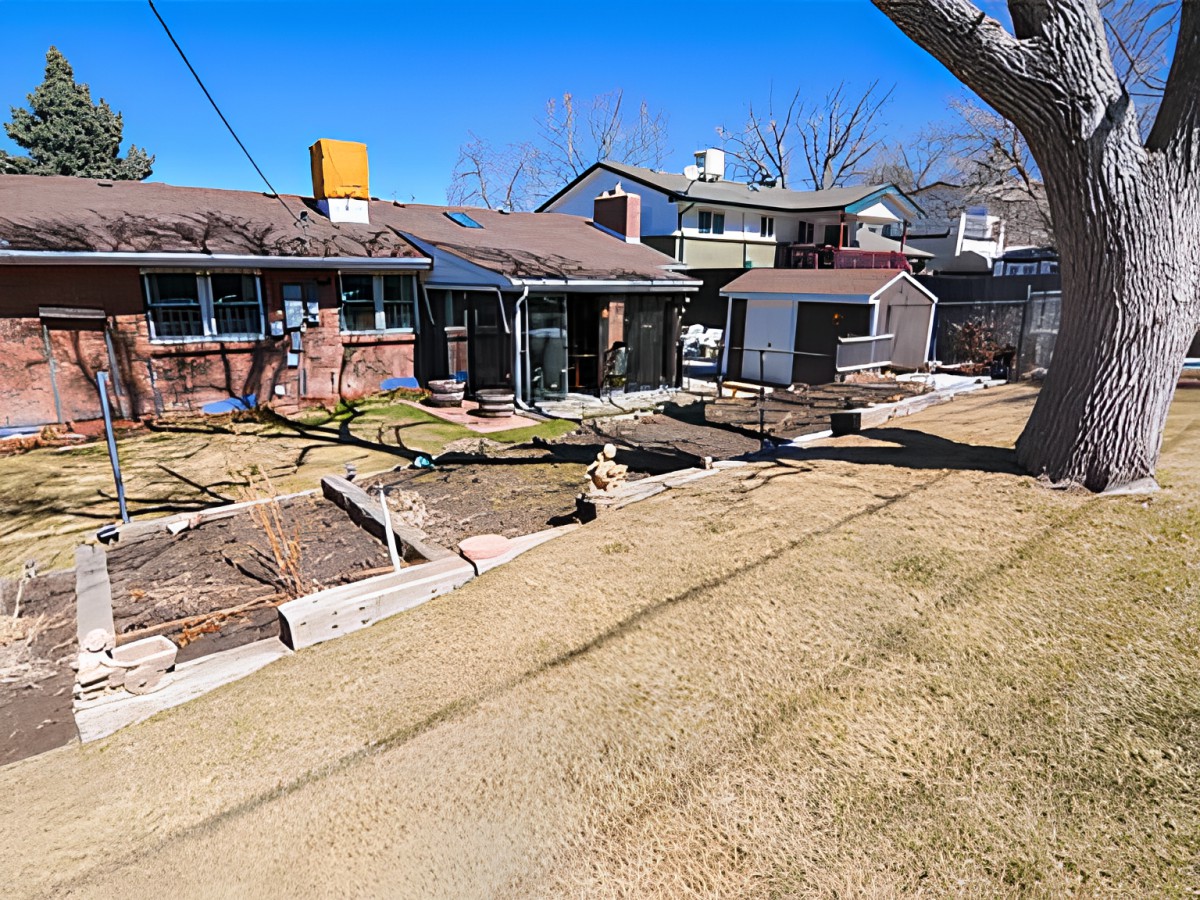 A view of a residential backyard with multiple houses and landscaped areas.