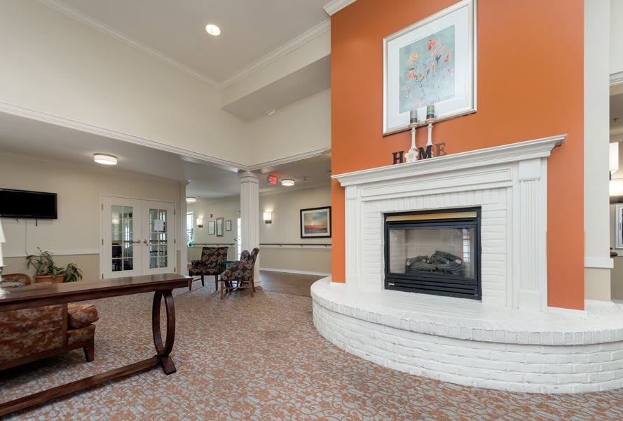 A modern living room interior featuring a stylish fireplace and elegant decor.