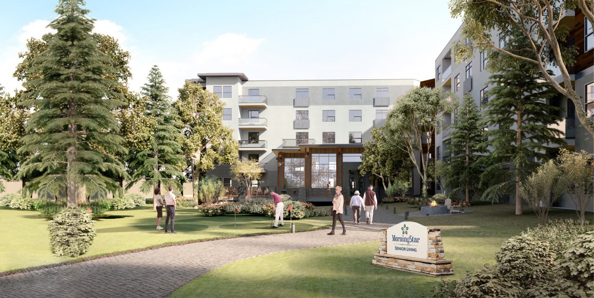 A modern residential building with people walking in the landscaped garden.