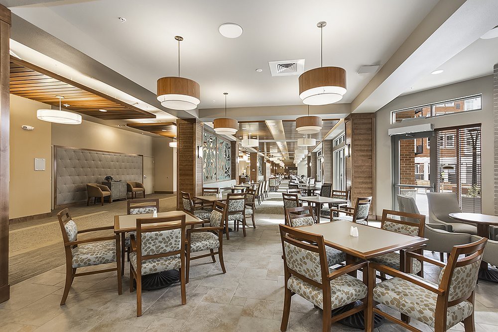 A modern dining area with wooden furniture and stylish lighting.