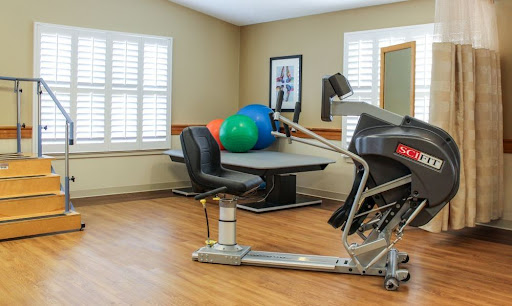 A well-equipped exercise space featuring fitness equipment and colorful exercise balls.