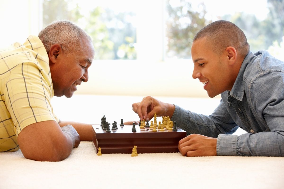 Two people enjoying a game of chess indoors.
