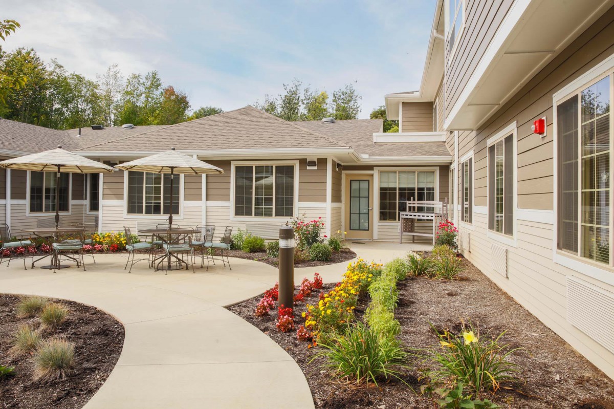 A well-maintained residential patio with outdoor seating and landscaped garden.