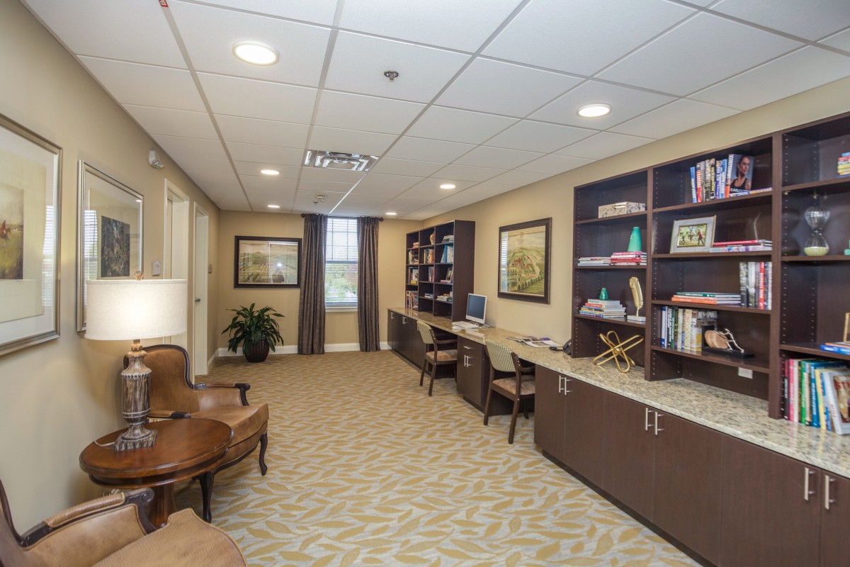 A spacious office with workstations, bookshelves, and comfortable seating.