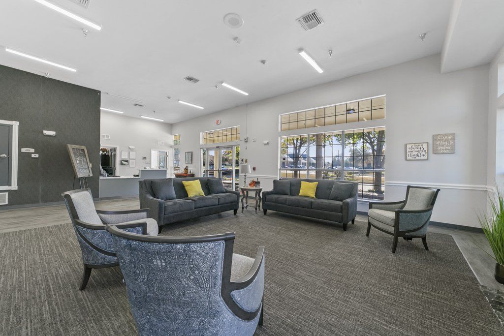 A modern lobby with comfortable seating and large windows.