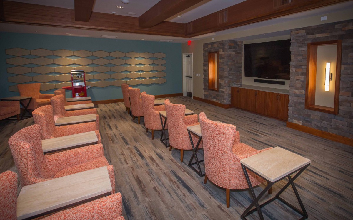 A modern meeting room with a large screen and organized seating.