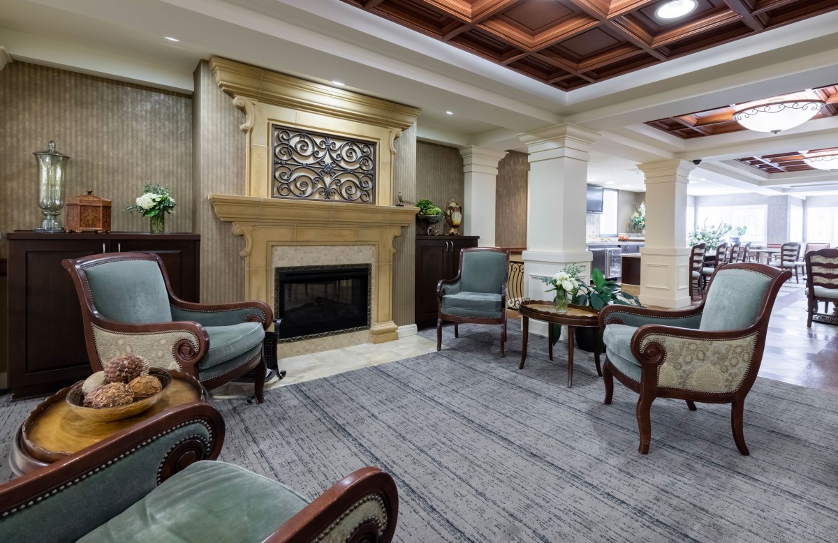 A traditional living room with a fireplace and elegant seating arrangement.