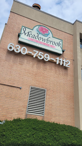 Sign for Meadowbrook displaying contact information.