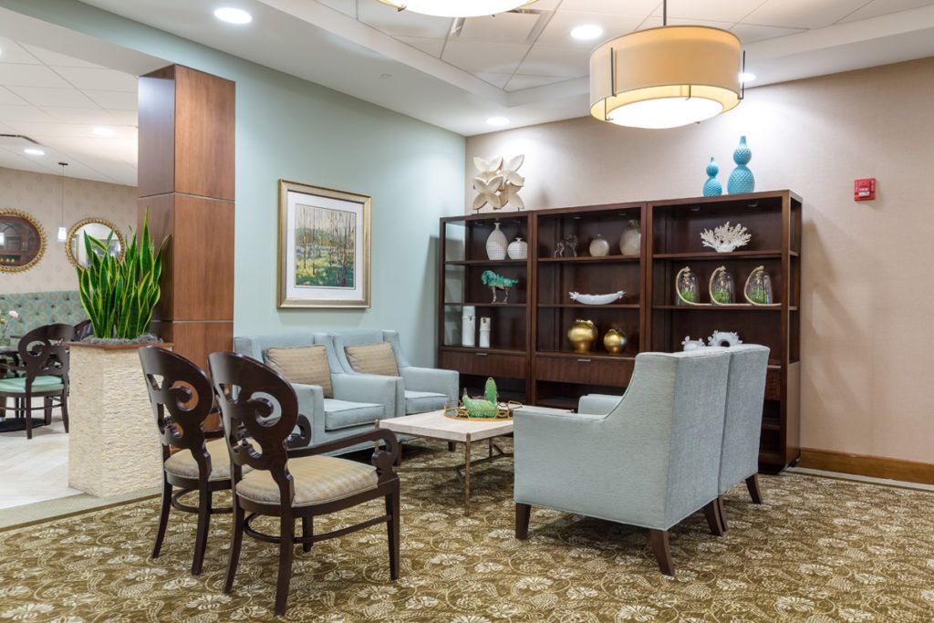 A cozy waiting room with comfortable seating, elegant decor, and modern lighting.