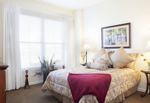 A serene and inviting bedroom featuring soft bedding, natural light, and decorative accents.