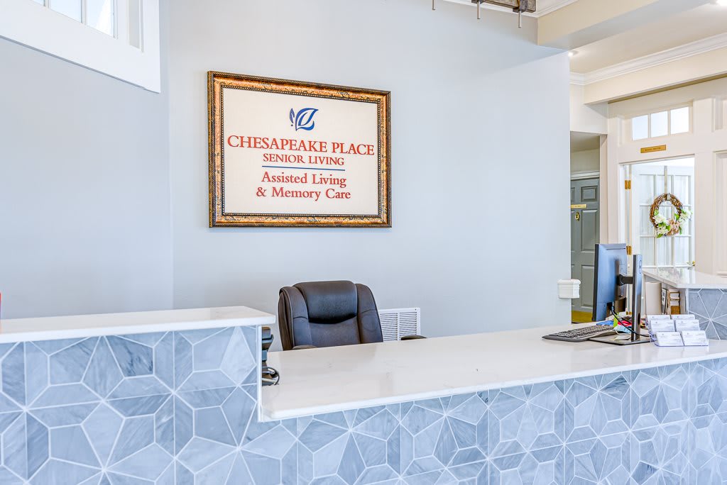 Reception area with a desk and signage for Chesapeake Place Assisted Living.