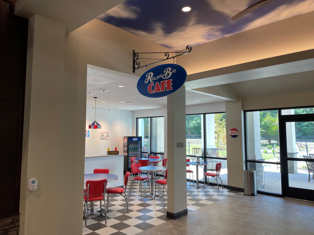 A retro-themed diner with red chairs and a checkered floor.