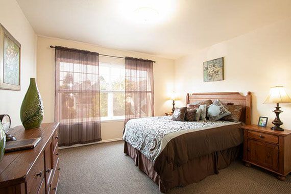 A cozy bedroom with a large bed, soft lighting, and elegant decor.