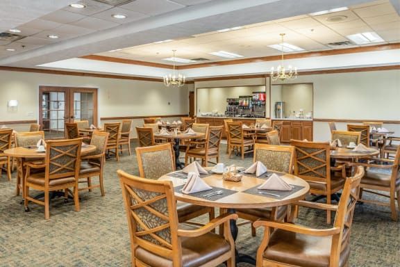 A neatly arranged dining area with tables set for guests.