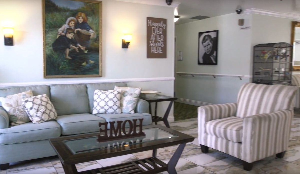 A cozy living room with comfortable seating and decorative artwork on the walls.