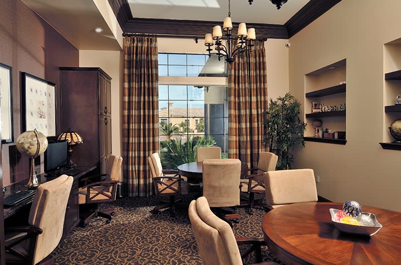 A well-appointed conference room with elegant furnishings and ample natural light streaming through a large window.