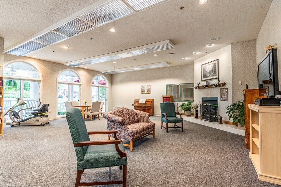 A spacious living room with comfortable seating and a cozy fireplace.