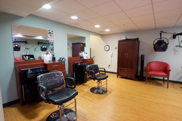 A well-organized salon interior with chairs and mirrors.