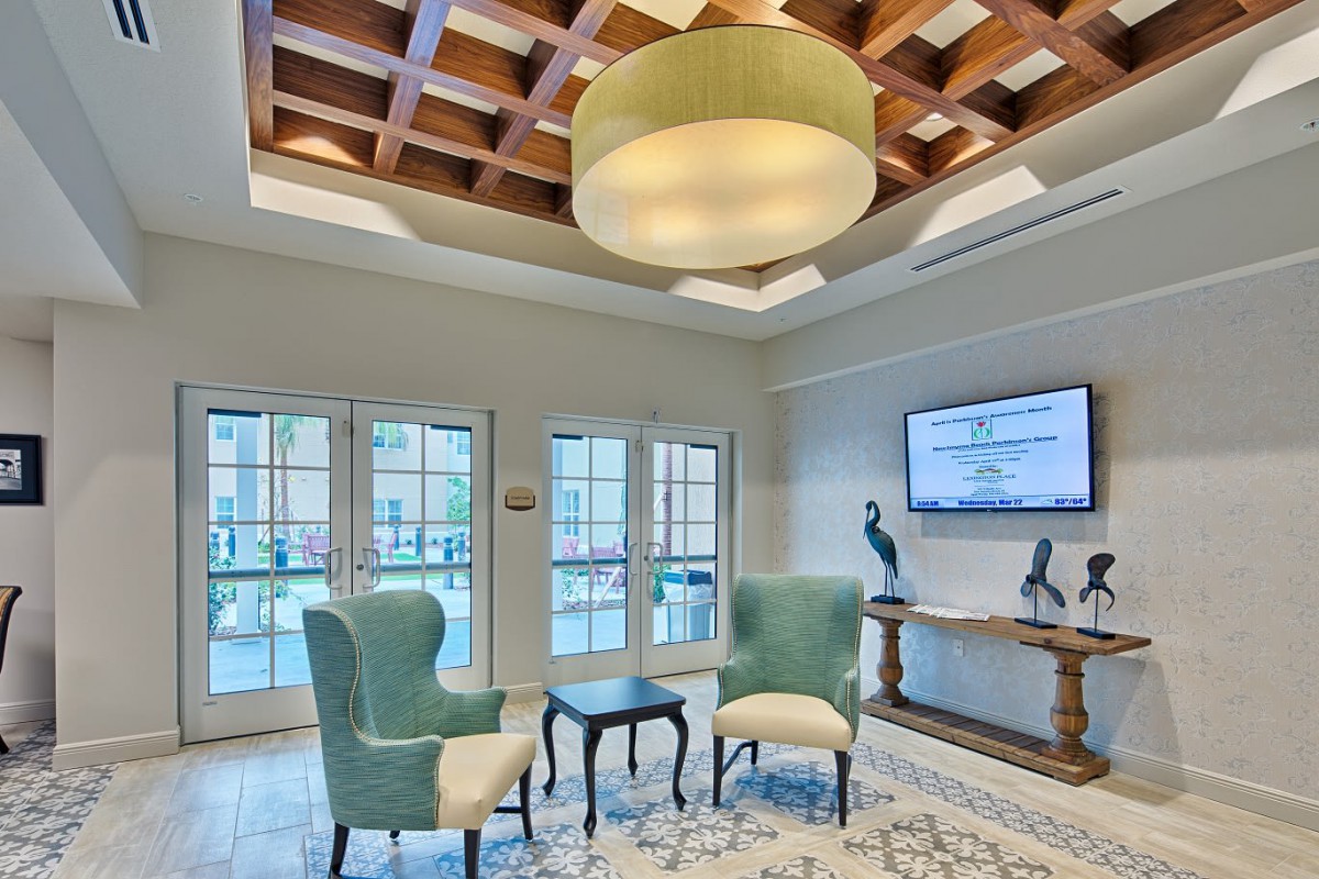 A cozy living room with stylish furniture and a modern chandelier.