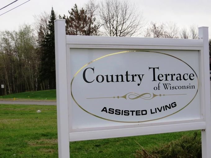 A sign for Country Terrace of Wisconsin Assisted Living, located in an outdoor setting.
