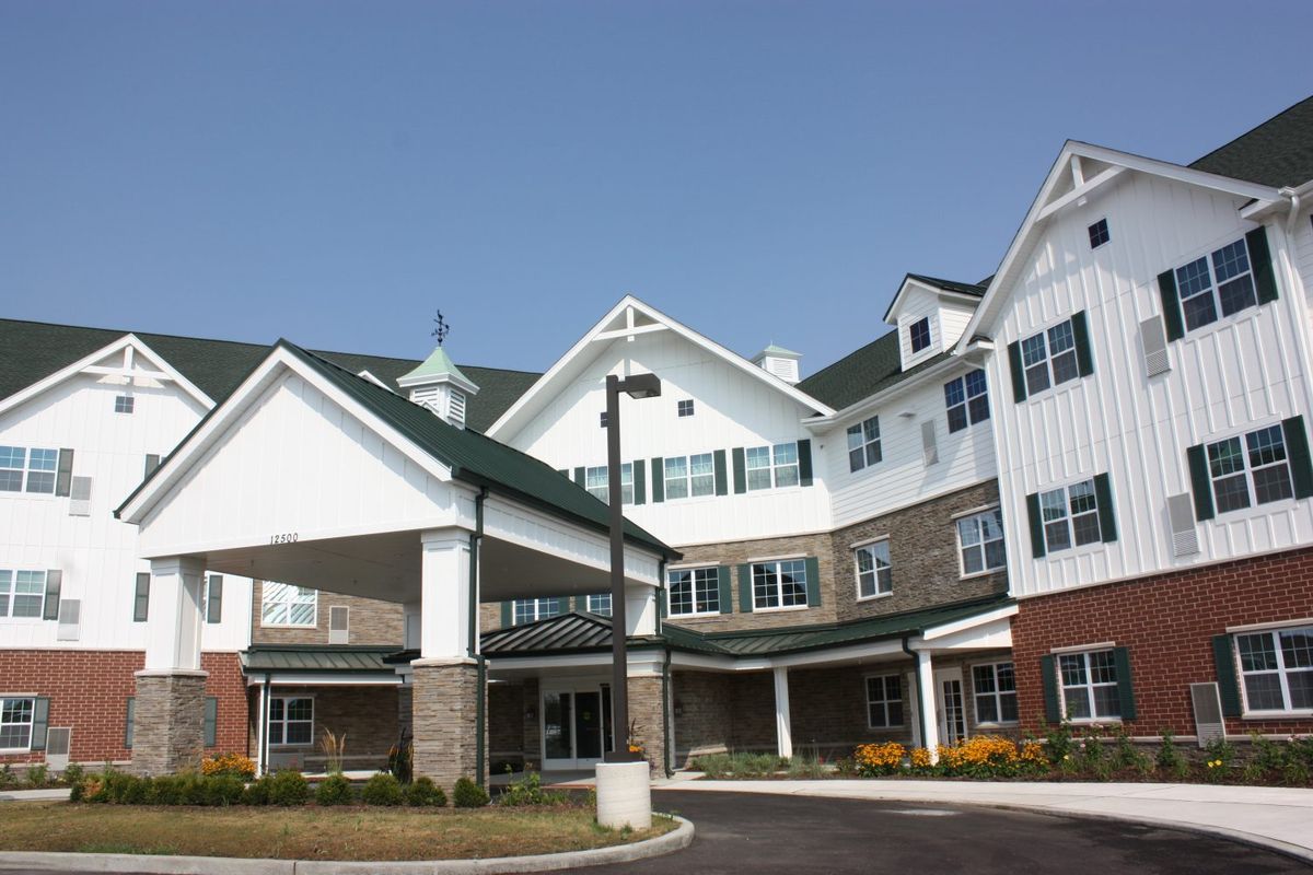 A modern residential building with multiple stories, possibly a senior living or retirement home.
