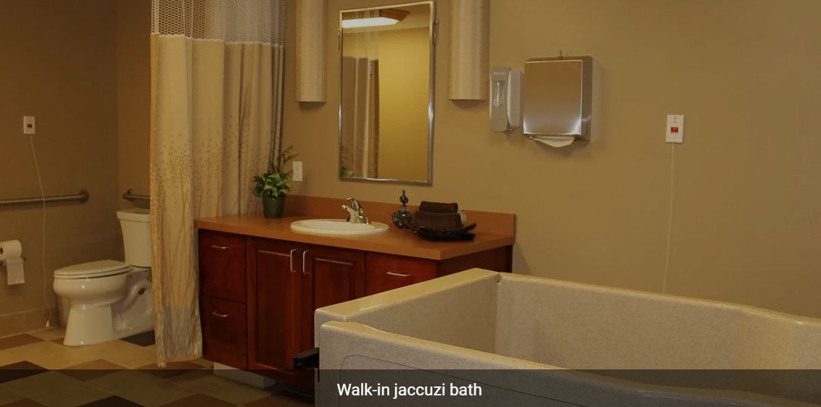 A luxurious bathroom with a walk-in jacuzzi bath.
