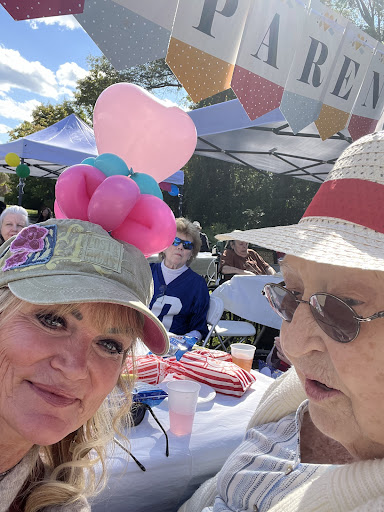Enjoying a lively outdoor event with festive hats and colorful balloons!