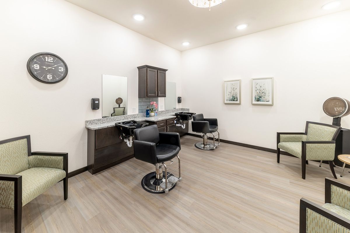 A modern salon interior with styling chairs and mirrors.