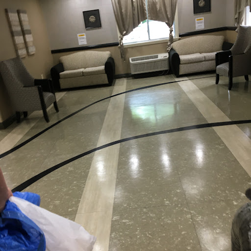 A cozy lobby area featuring elegant couches and a polished floor.