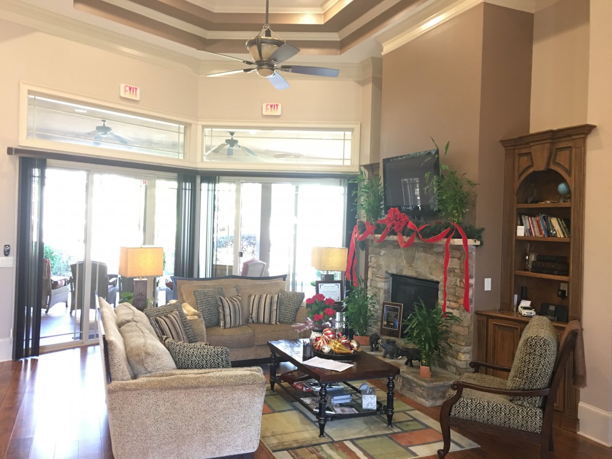 A cozy living room with a fireplace, decorated for the holidays.