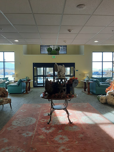 A spacious and inviting lobby featuring comfortable seating, elegant decor, and plenty of natural light.
